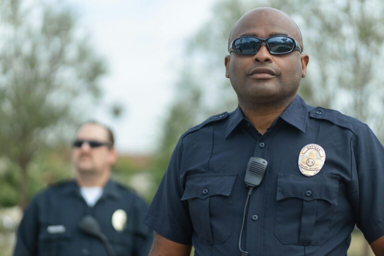 Police officers standing outdoors ensuring public safety. Law enforcement teamwork and professionalism.